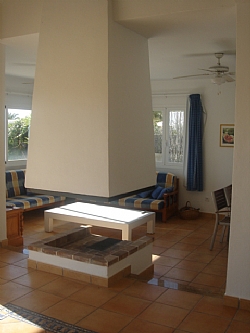 interior living room with fireplace of a rental house in ibiza