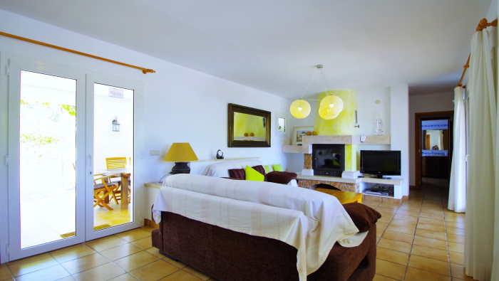 living room with fireplace in a rental house of Ibiza